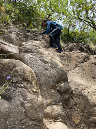 Ira Bornstein Scrambling up Rock Face on Kauai's Sleeping Giant Trail