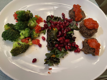 Broccoli with tomatoes, greens with pomegranates and oranges, walnut and mushroom meatballs with marinara sauce
